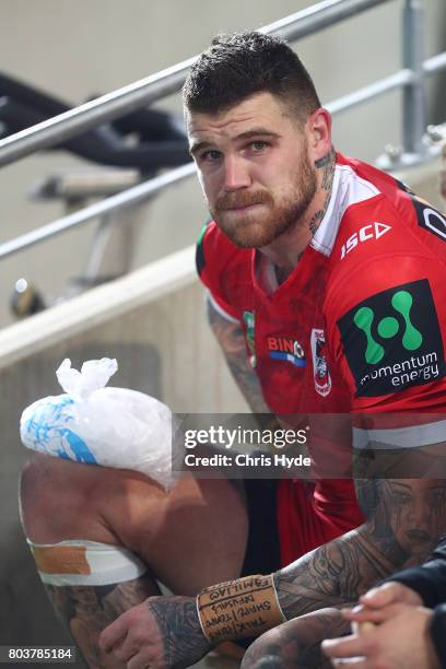 Josh Dugan of the Dragons sits on the sideline during the round 17 NRL match between the Gold Coast Titans and the St George Illawarra Dragons at...