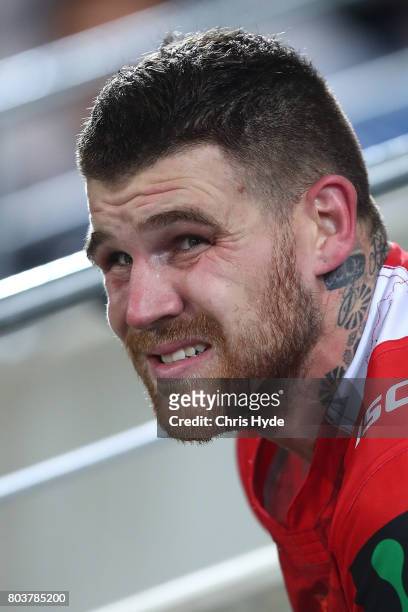Josh Dugan of the Dragons sits on the sideline during the round 17 NRL match between the Gold Coast Titans and the St George Illawarra Dragons at...