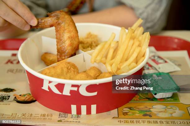 Food box filled with fried chicken and chips. Since the opening of the first KFC in Beijing in 1987, KFC has been in China for 30 years.