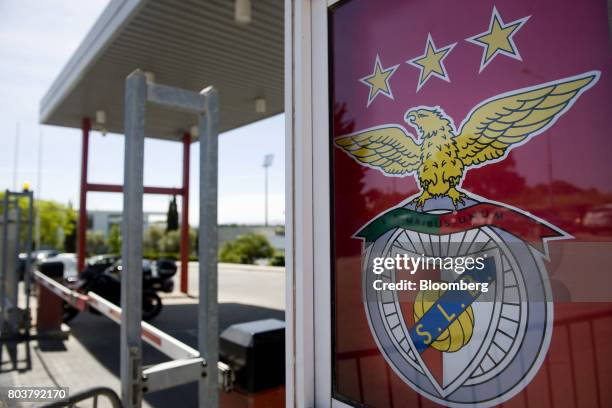 Logo sits on display at the entrance to Sport Lisboa e Benfica's 'Caixa Futebal' youth training campus in the Seixal district of Lisbon, Portugal, on...