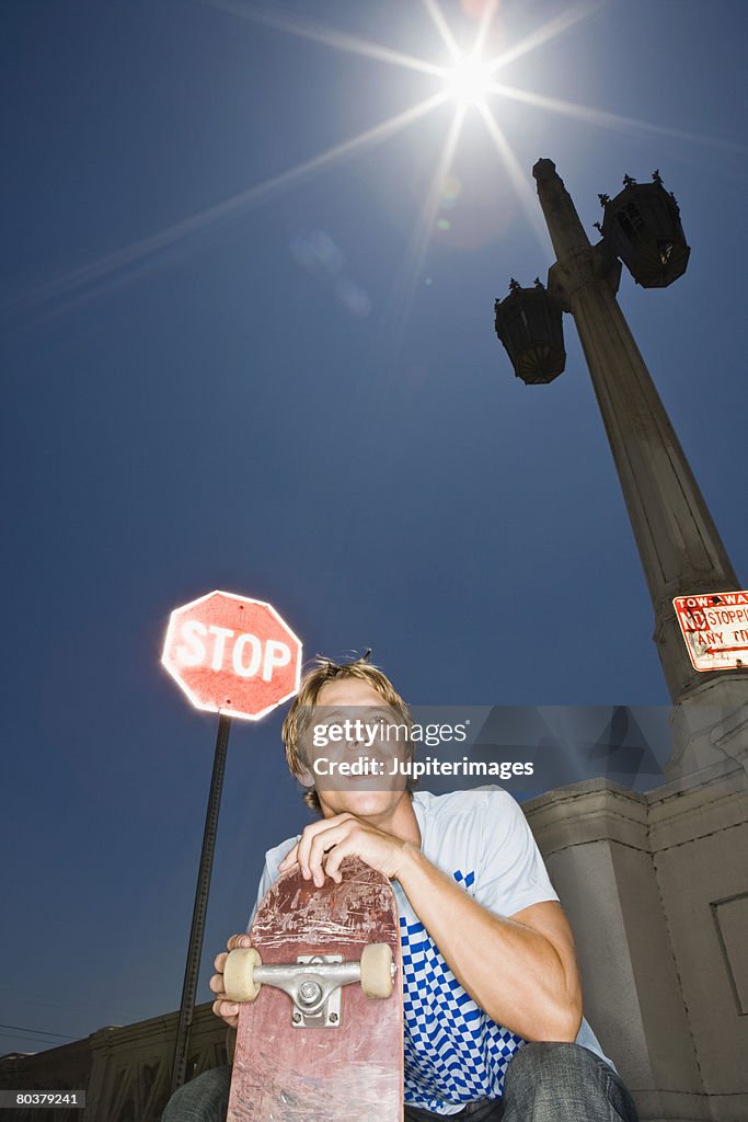 Smiling man with skateboard