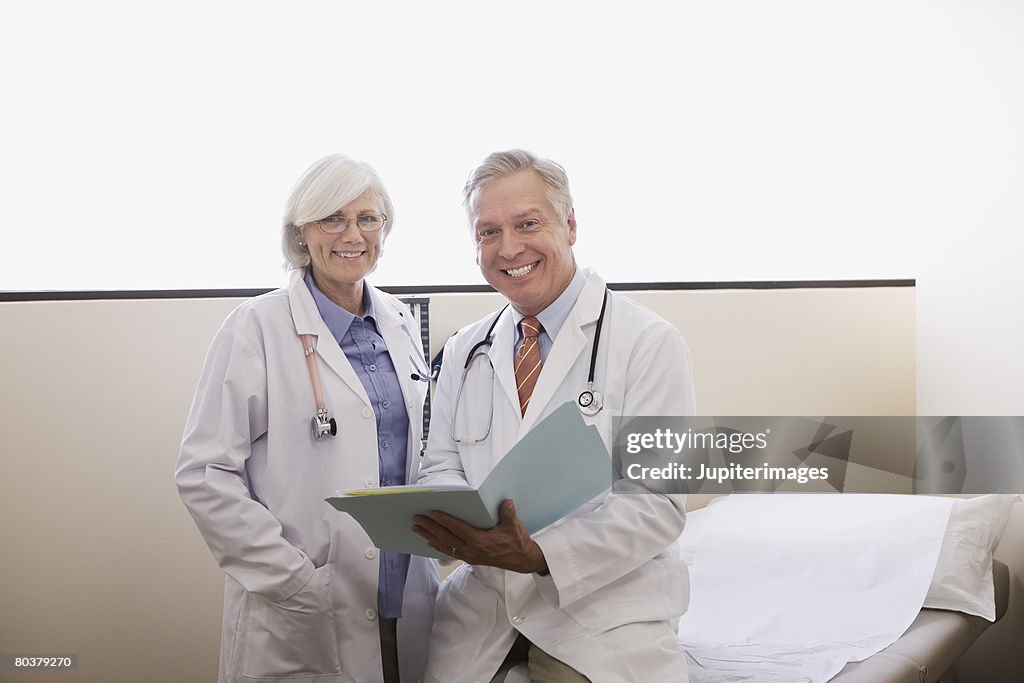 Smiling doctors with file