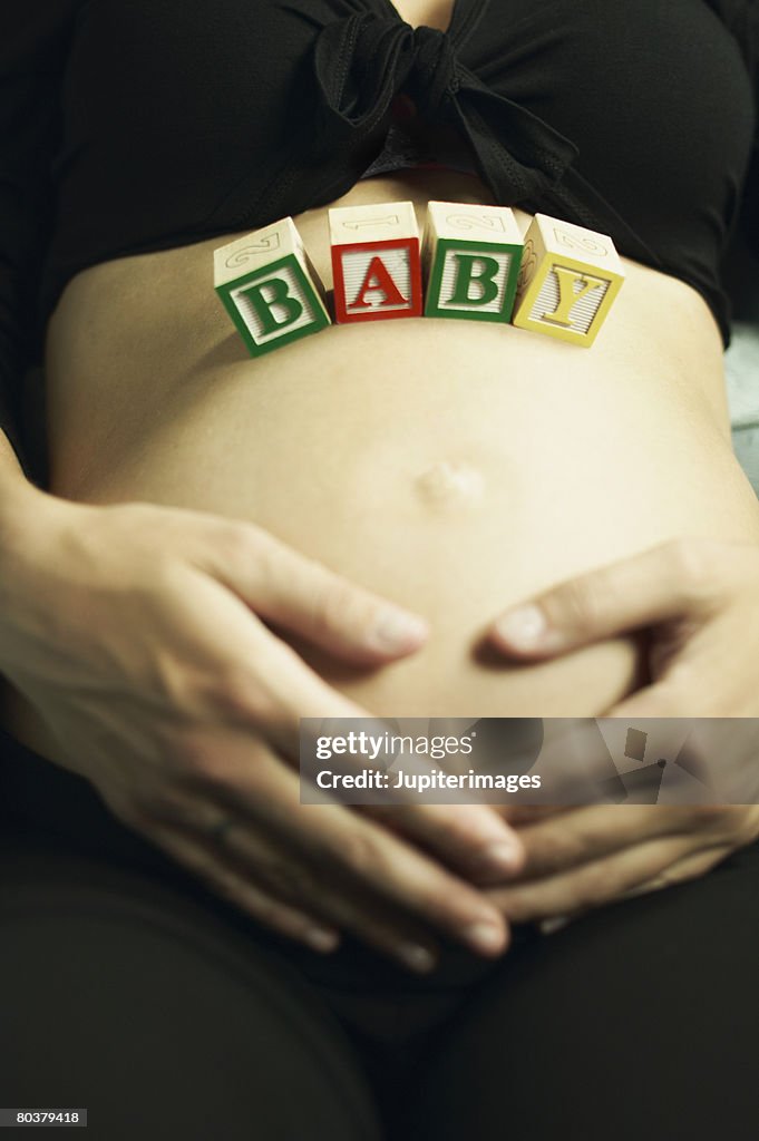 Pregnant woman with blocks on belly
