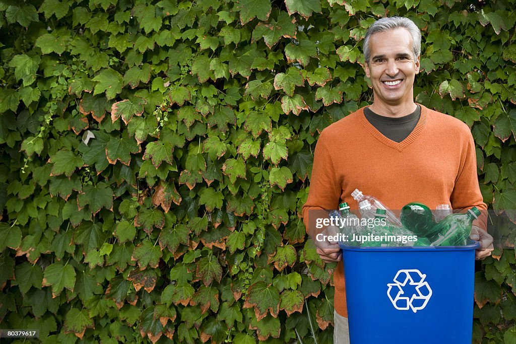 Man with recycling bin and ivy