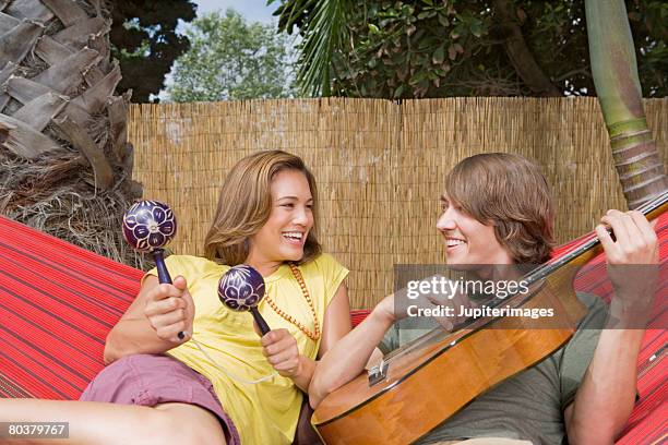 couple with maracas and guitar - maracas stock pictures, royalty-free photos & images