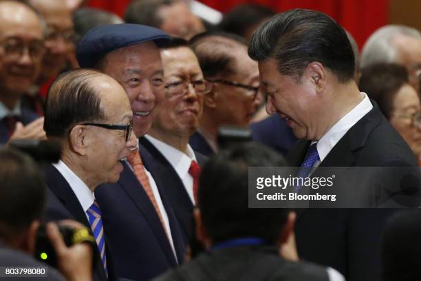 Xi Jinping, China's president, right, greets billionaire Li Ka-shing, chairman of CK Hutchison Holdings Ltd. And Cheung Kong Property Holdings Ltd.,...