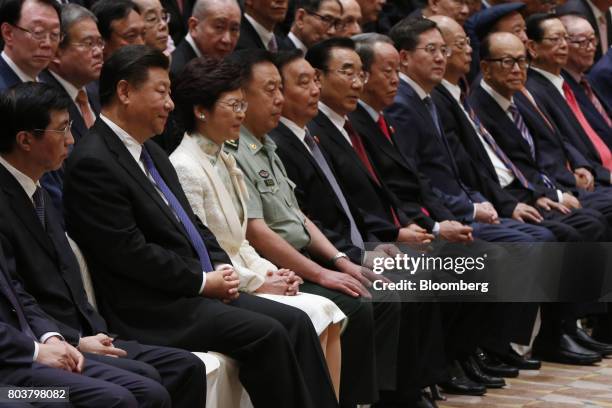 Xi Jinping, China's president, second left, and Carrie Lam, Hong Kong's chief executive-elect, third left, sit as billionaire Li Ka-shing, chairman...