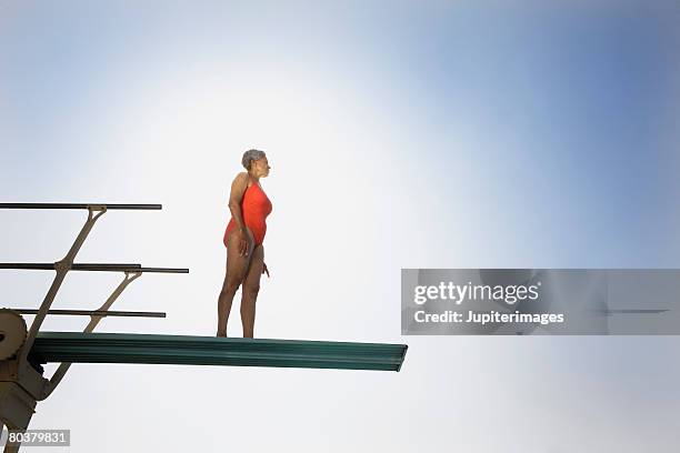 senior woman on high diving board - old people diving stock pictures, royalty-free photos & images