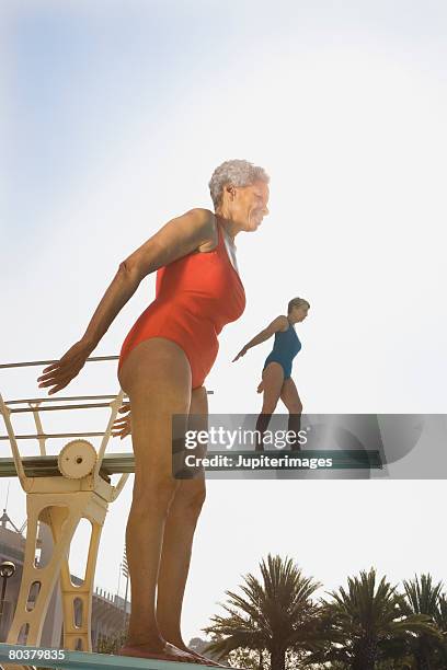senior women on diving boards - old people diving stock pictures, royalty-free photos & images