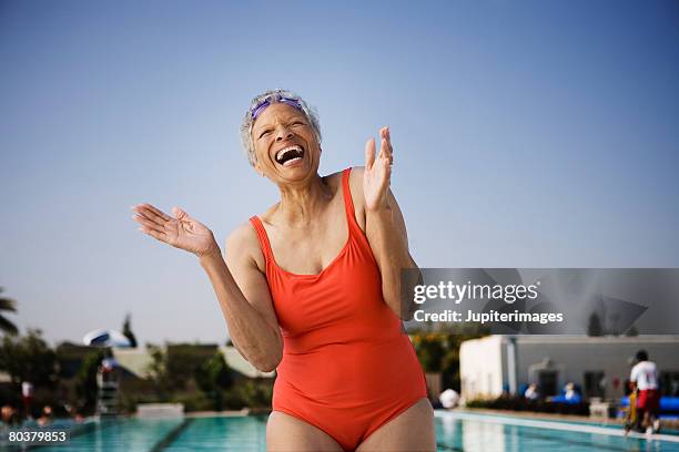 laughing senior woman swimmer - old woman in swimsuit stock-fotos und bilder