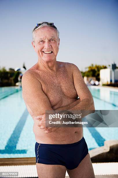 smiling senior man swimmer - zwembroek stockfoto's en -beelden