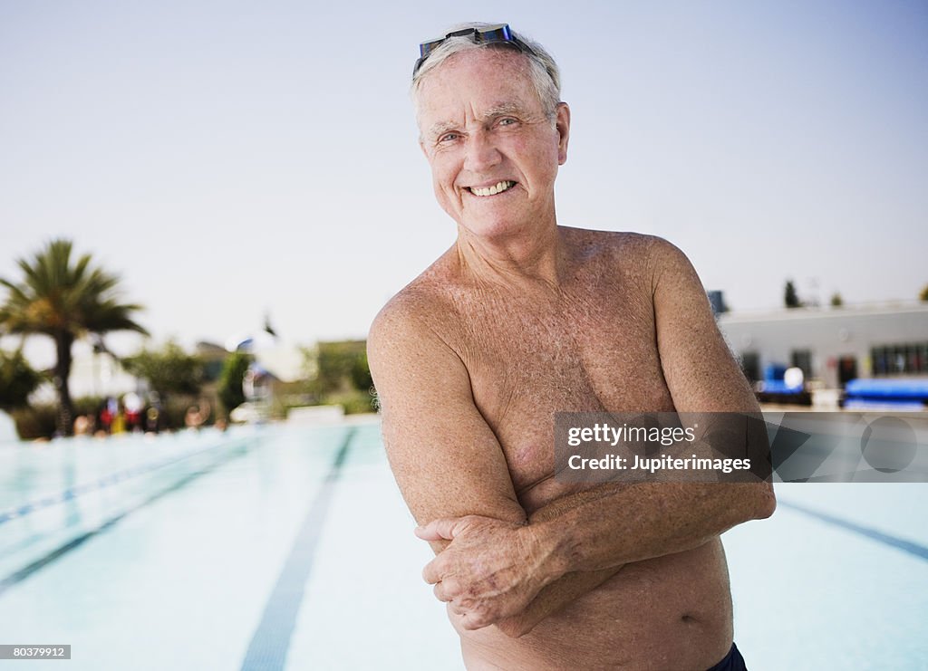 Smiling senior man swimmer at pool