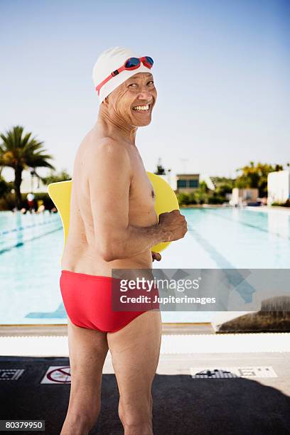smiling senior man swimmer at pool - man on float stock pictures, royalty-free photos & images
