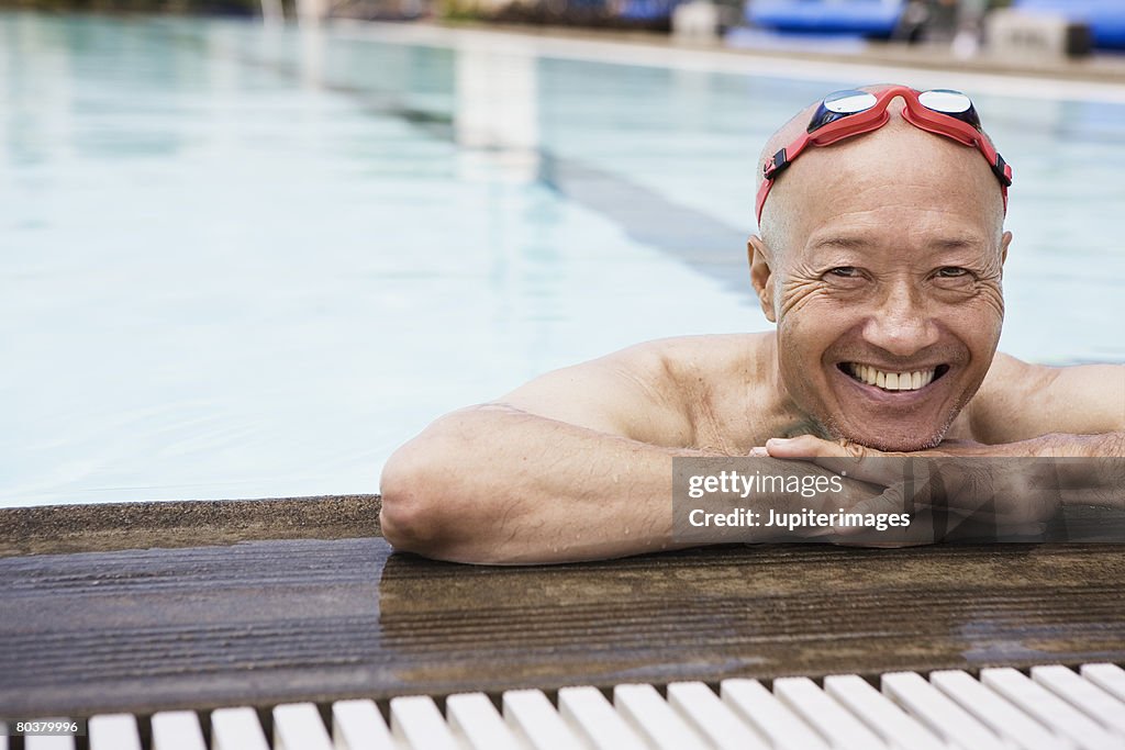 Smiling senior man swimmer wearing goggles