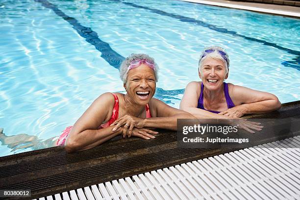 smiling senior women in pool - exercise swim stock-fotos und bilder