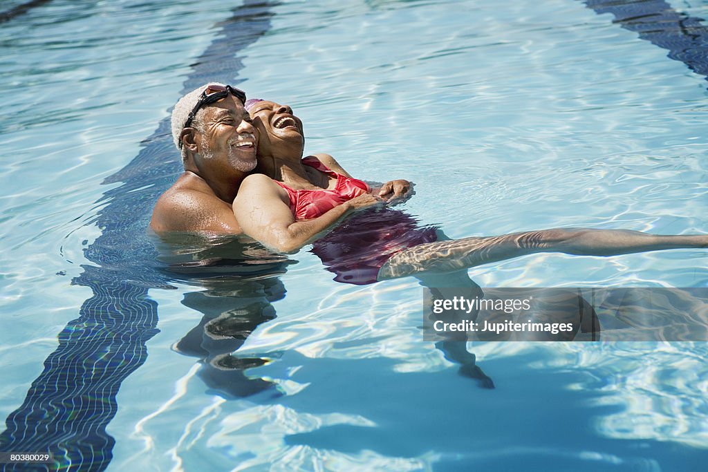 Senior couple embracing in pool