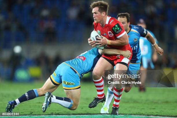 Josh McCrone of the Dragons runs the ball during the round 17 NRL match between the Gold Coast Titans and the St George Illawarra Dragons at Cbus...