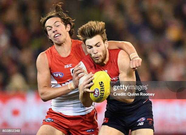 Jack Viney of the Demons marks infront of Oliver Florent of the Swans during the round 15 AFL match between the Melbourne Demons and the Sydney Swans...