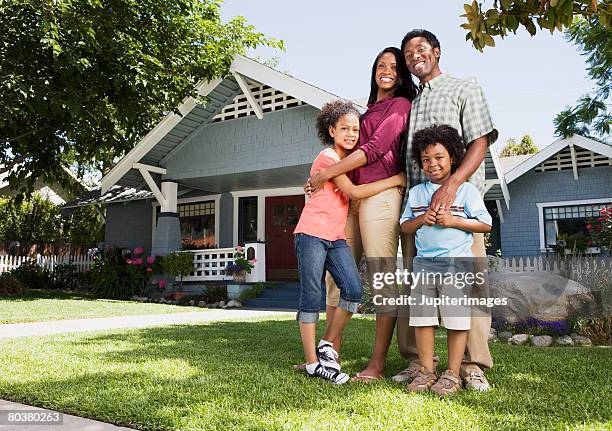 embracing family in front of home - family in front of home fotografías e imágenes de stock