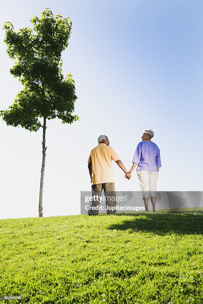 Senior couple holding hands