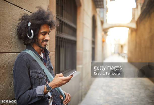 young trendy man in barcelona. - streaming music stock pictures, royalty-free photos & images