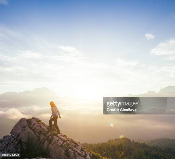 female silhouette on top of mountain peak during sunrise - beautiful romanian women stock pictures, royalty-free photos & images