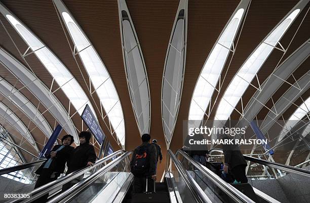 Passengers are seen in the main departures hall of the new terminal two at the Pudong International Airport in Shanghai on March 26, 2008. The new...