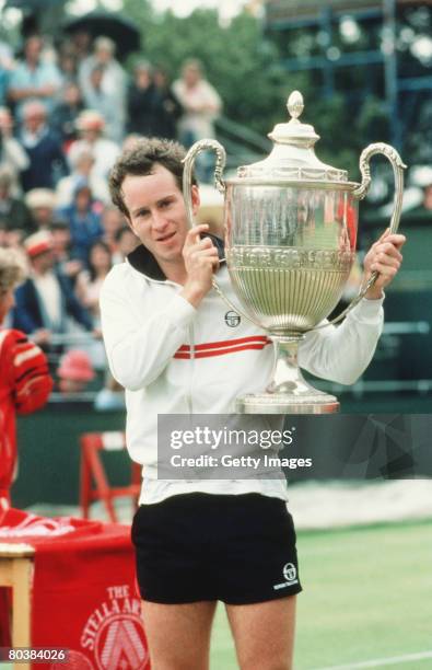 John McEnroe with the trophy at the Stella Artois Tennis Championship held at the Queen's Club, in London, England.