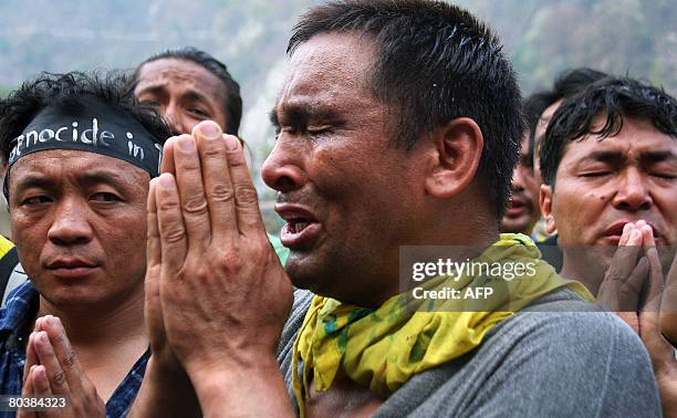 Tibetan activists in exile offer condolence prayers to Tibetans who died during an alleged crackdown by Chinese troops in Tibet, at the West...