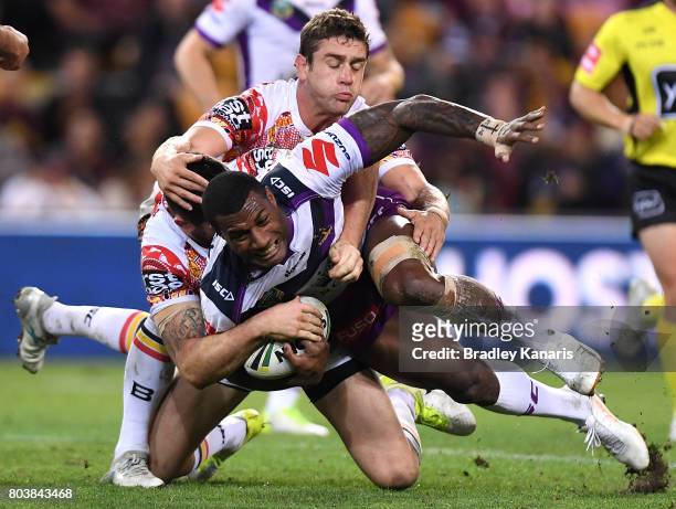 Sullies Vunivalu of the Storm is tackled during the round 17 NRL match between the Brisbane Broncos and the Melbourne Storm at Suncorp Stadium on...
