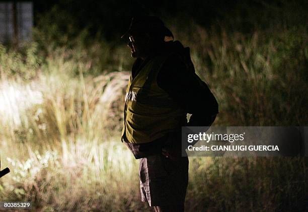 South African farmer Jacques Bouwer patrols on March 17, 2008 the farming area of Waterpoort in South Africa in search of Zimbabwean illegal...