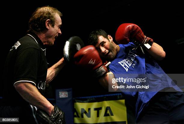 Joe Calzaghe spars with his father and trainer Enzo Calzaghe during his open workout prior to his fight against Bernard Hopkins in Las Vegas, Nevada...