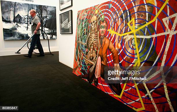 Cleaner walks past the painting The Ocular Circus of Cezanne,by Steven Campbell at the 13th Glasgow Art Fair March 26, 2008 in Scotland. Scotland's...