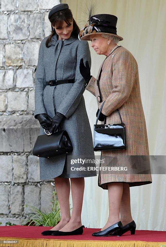 Britain's Queen Elizabeth II (R) talks t