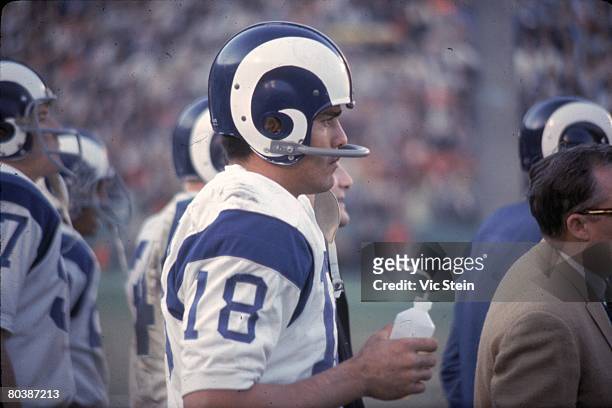 Quarterback Roman Gabriel of the Los Angeles Rams watches from the sideline during an NFL game against the Green Bay Packers at the Los Angeles...