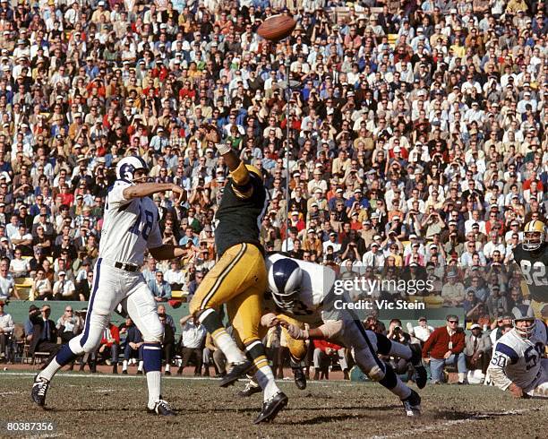 Quarterback Roman Gabriel of the Los Angeles Rams throws a pass during an NFL game against the Green Bay Packers at the Los Angeles Memorial Coliseum...