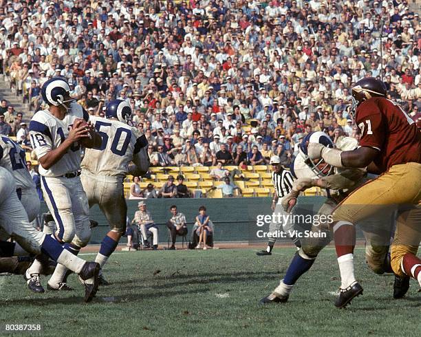 Quarterback Roman Gabriel of the Los Angeles Rams sets up to pass during an NFL game against the Washington Redskins at the Los Angeles Memorial...