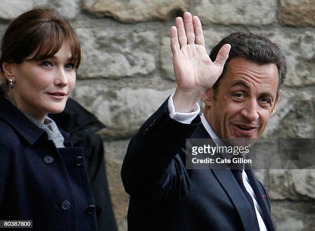 President Nicolas Sarkozy of France waves to the public as he and his wife Carla Bruni-Sarkozy leave Westminster Abbey after laying a wreath at the...