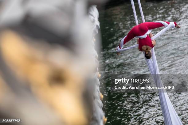 An acrobat shows a dance suspended from the Pont Alexandre III on June 24, 2017 in Paris, France. On 23 and 24 June, Paris is transformed into an...