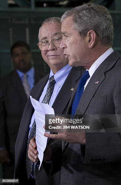 President George W. Bush holds an Internal Revenue Service mailer that was sent out to citizens explaining the benefits of the Economic Stimulus...