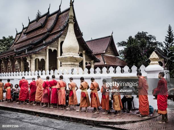 alms giving ceremony luang prabang laos - alms stock pictures, royalty-free photos & images