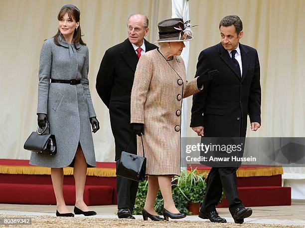 Carla Bruni-Sarkozy, Prince Philip, Duke of Edinburgh, Queen Elizabeth II and French President Nicolas Sarkozy inspect the guards during a welcome...