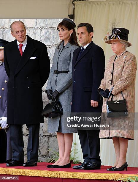 Prince Philip, Duke of Edinburgh, Carla Bruni-Sarkozy, French President Nicolas Sarkozy and Queen Elizabeth II inspect the guards during a welcome...