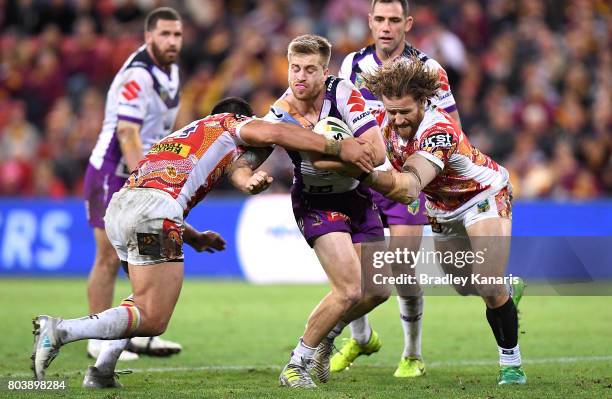 Cameron Munster of the Storm attempts to break through the defence during the round 17 NRL match between the Brisbane Broncos and the Melbourne Storm...