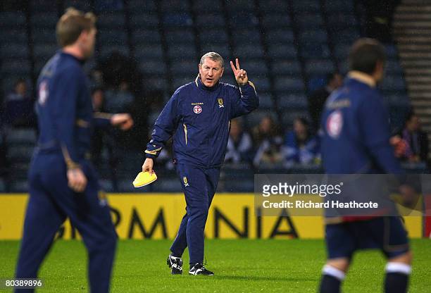 Terry Butcher, the Scotland assistant coach takes charge of the pre-match warm upduring the Tennent's International Challenge friendly match between...