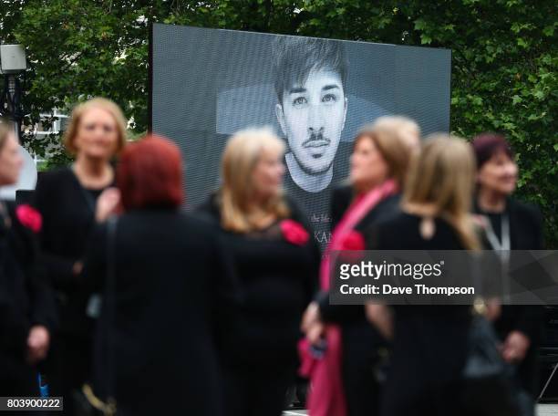 Screen displaying an image of Martyn Hett outside Stockport Town Hall as mourners arrive for his funeral on June 30, 2017 in Stockport, England. 29...