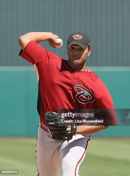 Yusmeiro Petit of the Arizona Diamondbacks pitches during a Spring Training game against the Los Angeles Angels of Anaheim at Tempe Diablo Stadium on...