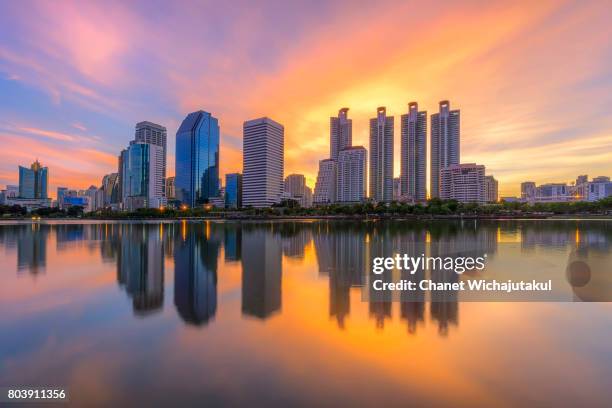 reflection of cityscape in the park at twilight time. - alberta city stock pictures, royalty-free photos & images