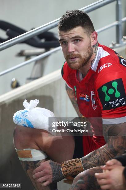 Josh Dugan of the Dragons sits on the sideline during the round 17 NRL match between the Gold Coast Titans and the St George Illawarra Dragons at...