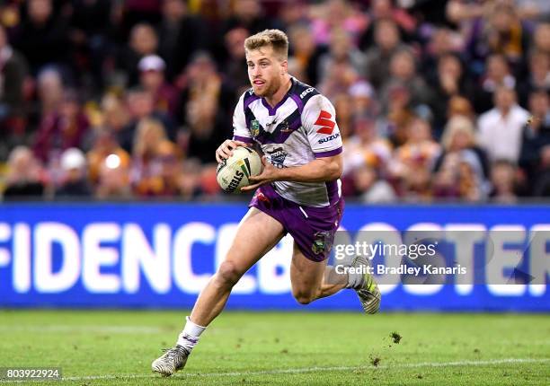 Cameron Munster of the Storm runs with the ball during the round 17 NRL match between the Brisbane Broncos and the Melbourne Storm at Suncorp Stadium...